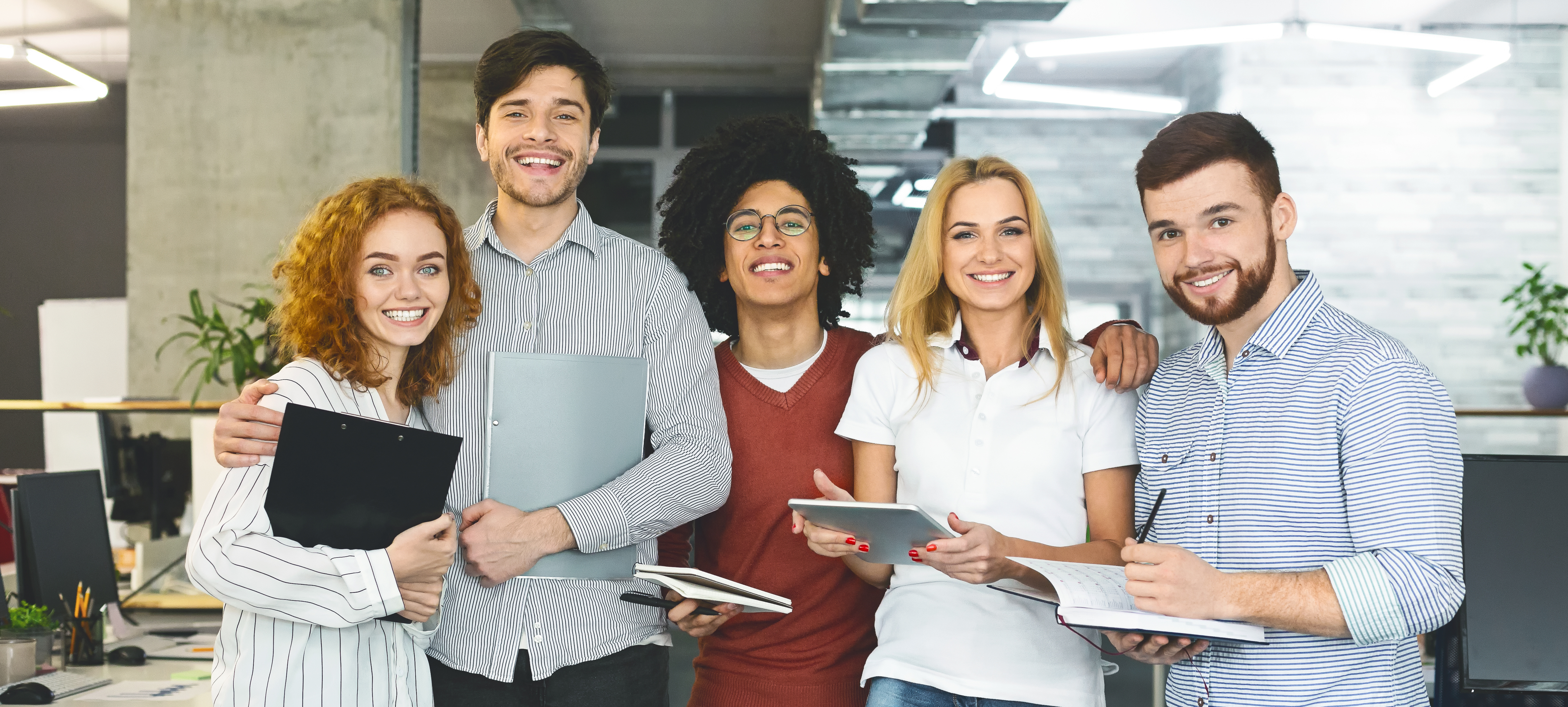 Diverse business people standing together and smiling.